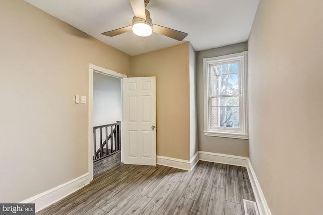 empty room with light hardwood / wood-style flooring and ceiling fan