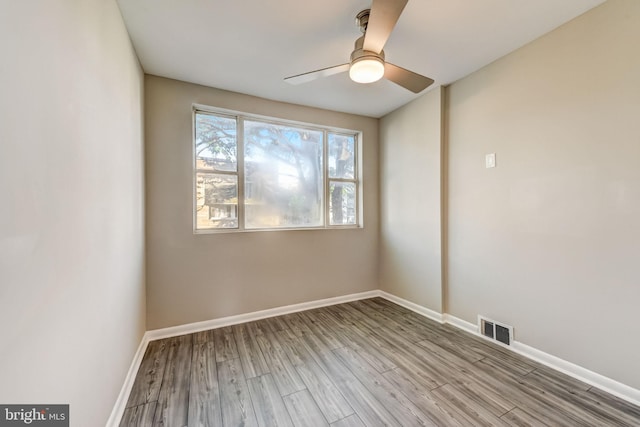 empty room with ceiling fan and light hardwood / wood-style floors