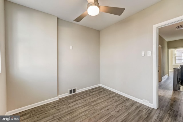 spare room featuring hardwood / wood-style flooring and ceiling fan