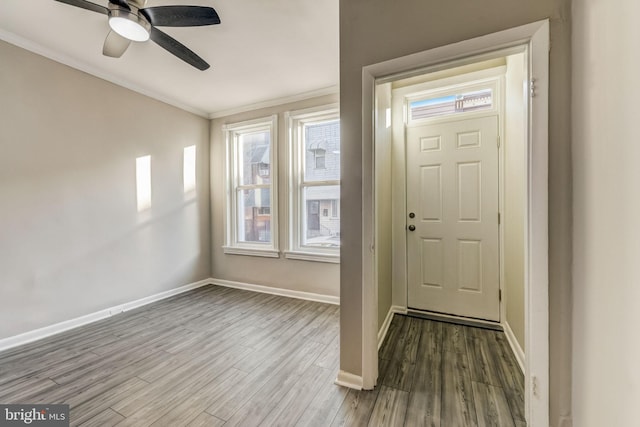 entryway featuring ceiling fan, hardwood / wood-style floors, and ornamental molding