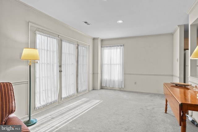 sitting room with light colored carpet and ornamental molding