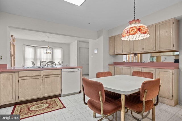 kitchen with dishwasher, pendant lighting, and light brown cabinets