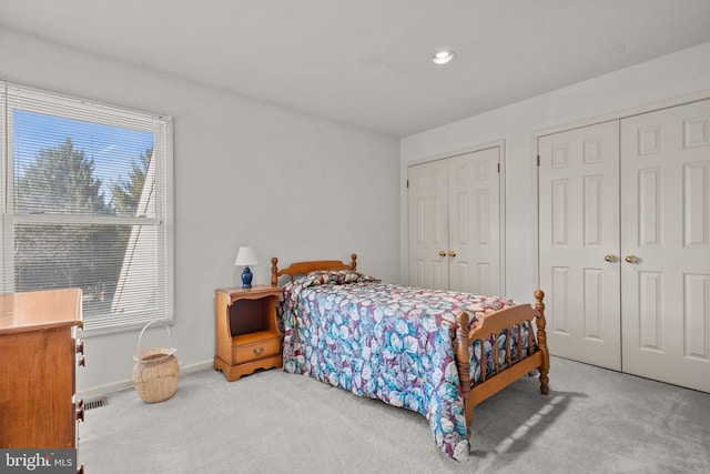 carpeted bedroom with two closets