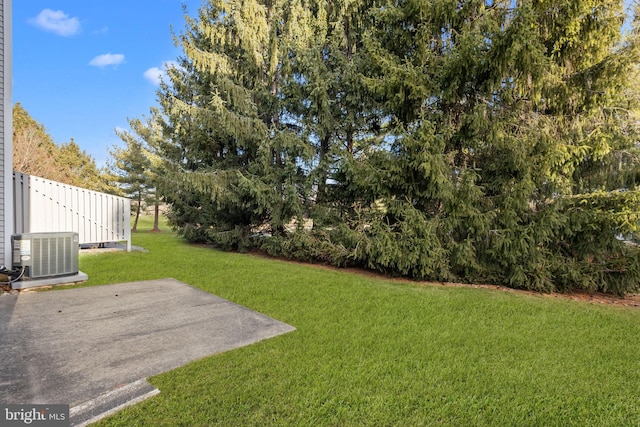 view of yard featuring central AC unit and a patio area