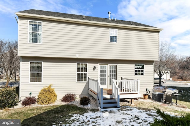 snow covered property featuring central AC