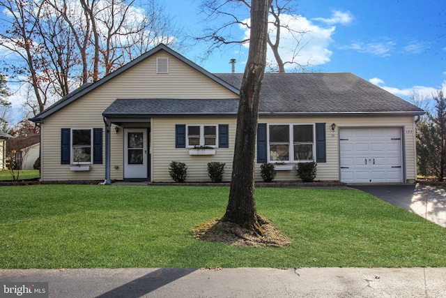 ranch-style home with a front yard and a garage