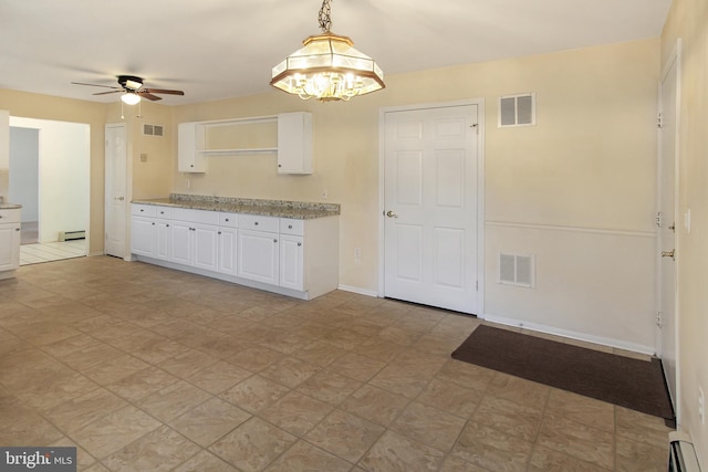 kitchen featuring white cabinets, pendant lighting, baseboard heating, and ceiling fan