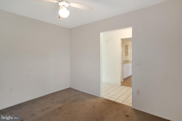 carpeted empty room featuring ceiling fan