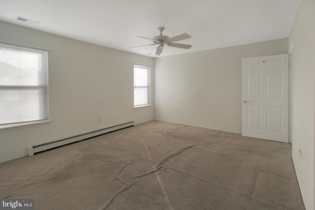 unfurnished room with light carpet, ceiling fan, and a baseboard heating unit