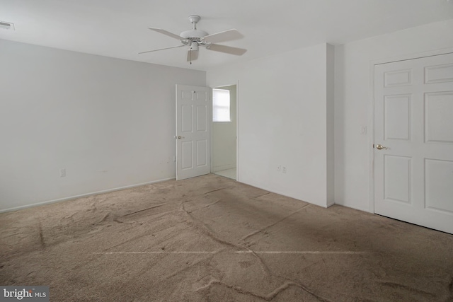 carpeted empty room featuring ceiling fan