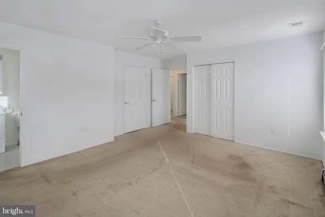 spare room with light colored carpet and ceiling fan