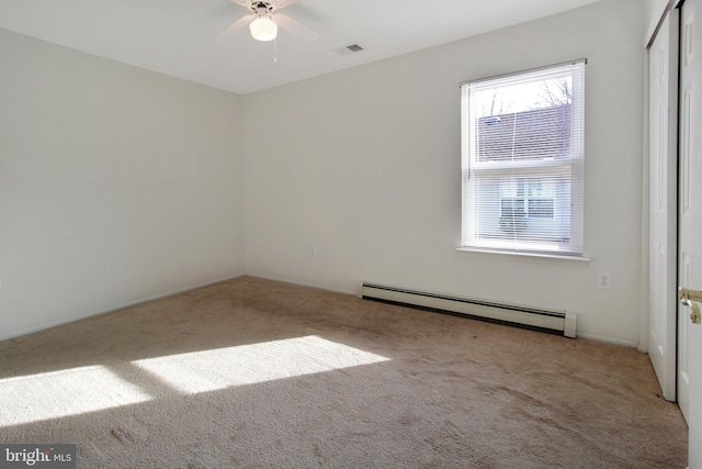 empty room featuring light carpet, ceiling fan, and a baseboard radiator