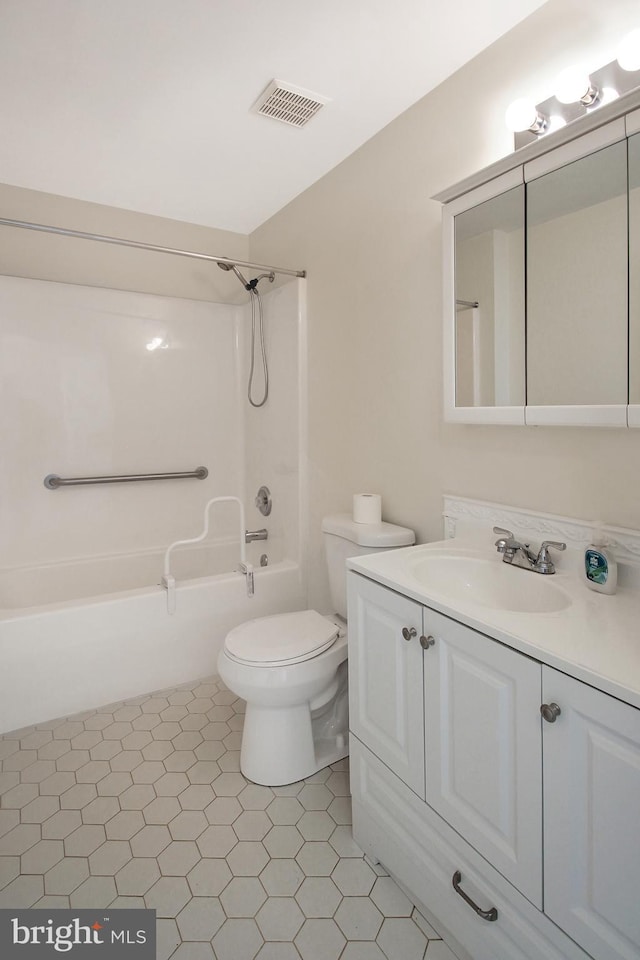 full bathroom with tile patterned flooring, vanity, shower / bathtub combination, and toilet