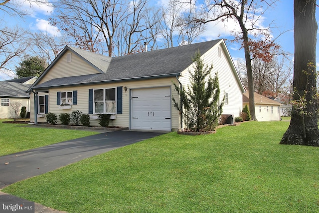 view of front of home with a front yard and a garage