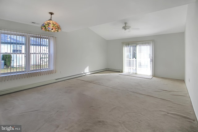 carpeted spare room with ceiling fan and a baseboard heating unit