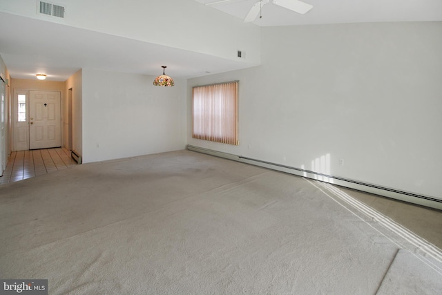 unfurnished room with light carpet, ceiling fan, and a baseboard heating unit