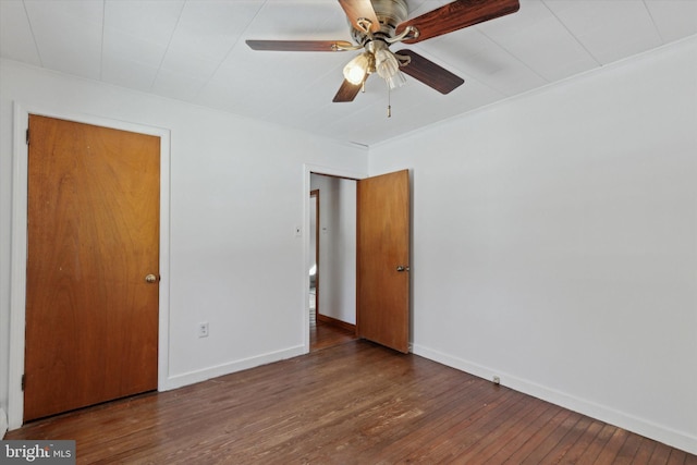 spare room featuring ceiling fan and dark wood-type flooring