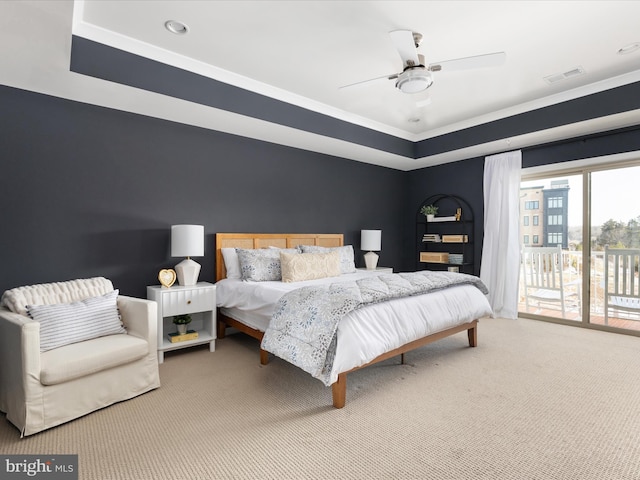 bedroom featuring carpet flooring, access to outside, ceiling fan, and a tray ceiling