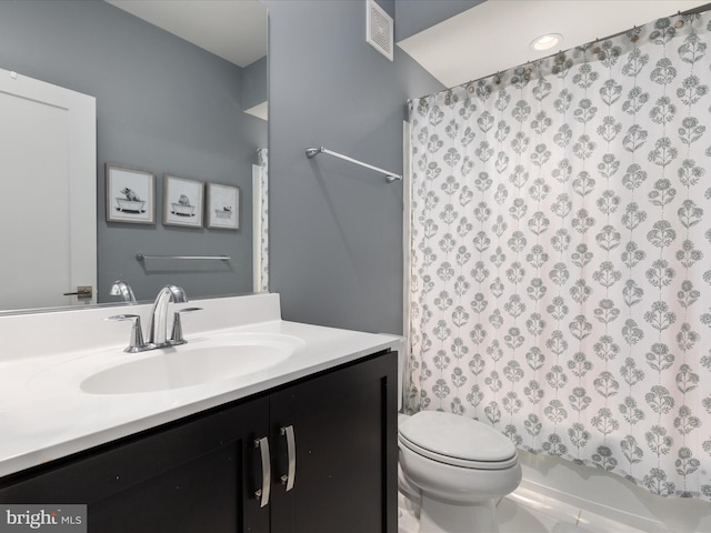 full bathroom featuring shower / tub combo, vanity, and toilet