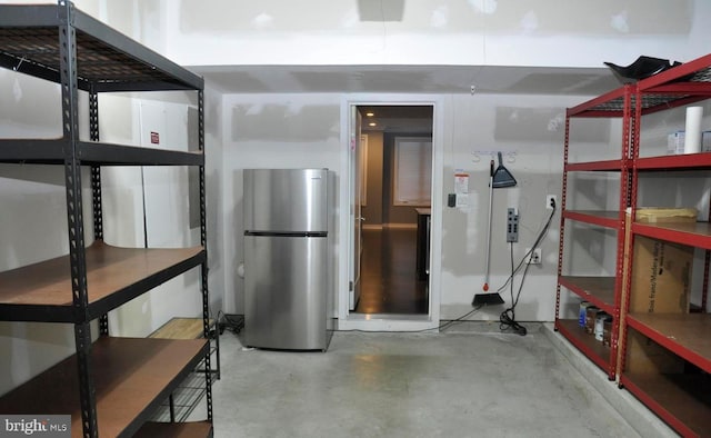 basement with stainless steel refrigerator