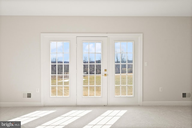 doorway featuring light carpet