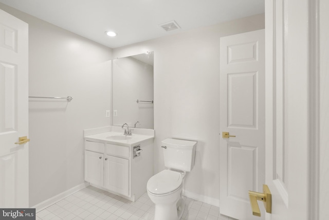 bathroom featuring tile patterned floors, vanity, and toilet