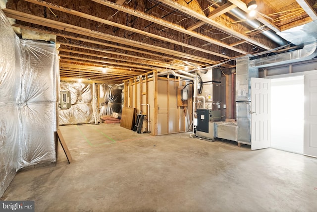 basement featuring heating unit and electric panel