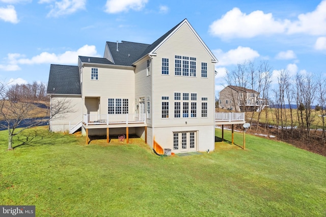 rear view of property with a yard, french doors, and a deck