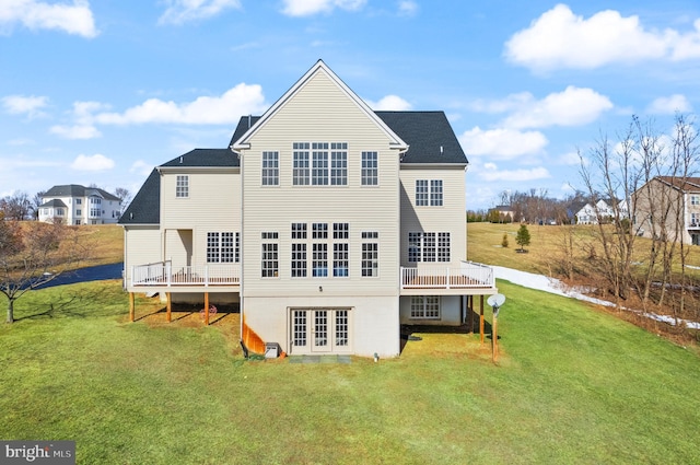 back of house featuring a wooden deck, a yard, and french doors