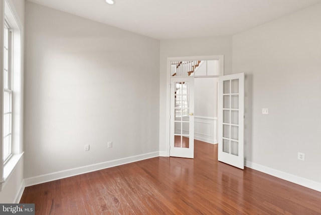 unfurnished room with french doors and dark hardwood / wood-style flooring