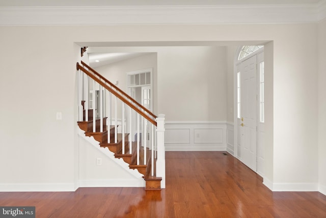 entrance foyer with crown molding and wood-type flooring