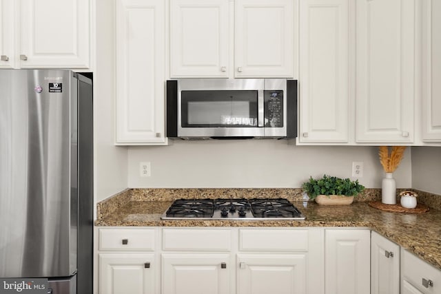 kitchen featuring white cabinetry and appliances with stainless steel finishes