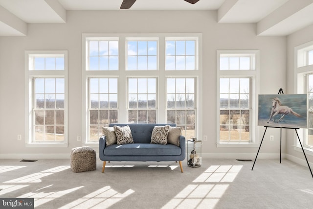 sunroom featuring ceiling fan and a healthy amount of sunlight