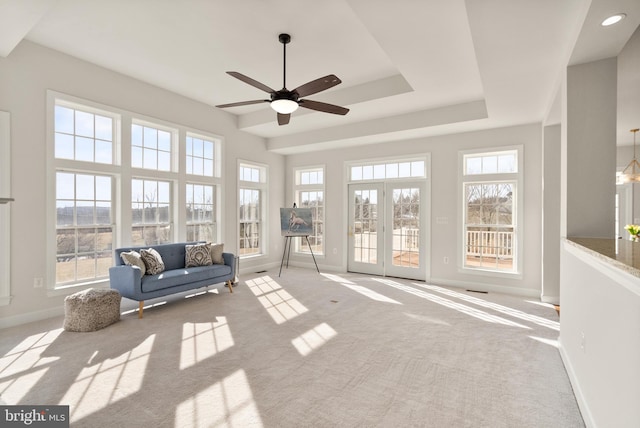 sunroom featuring ceiling fan and a tray ceiling