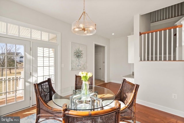 dining space with an inviting chandelier and hardwood / wood-style floors