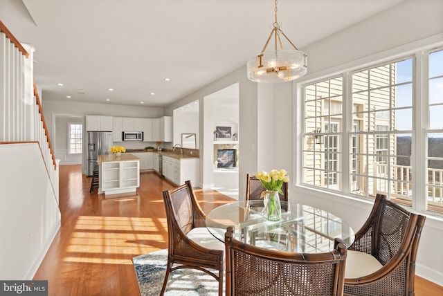 dining space with a chandelier and light hardwood / wood-style flooring