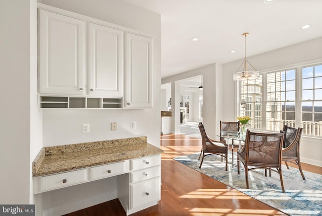 kitchen featuring light stone countertops and white cabinets