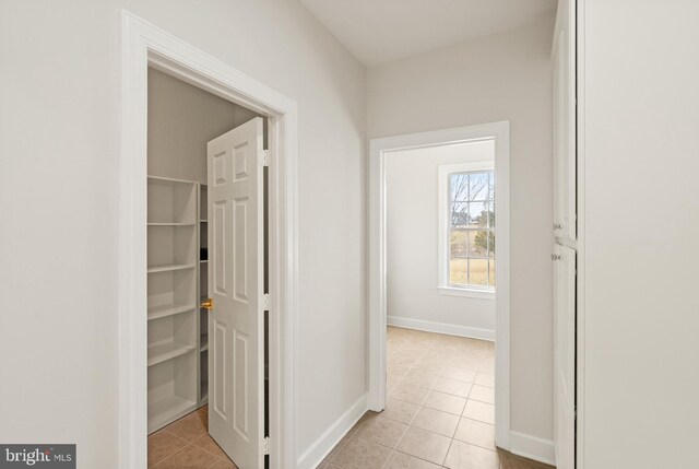 hall featuring light tile patterned floors