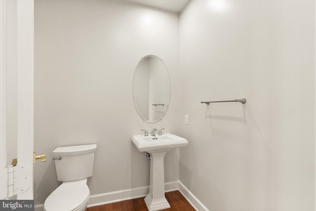 bathroom with wood-type flooring and toilet