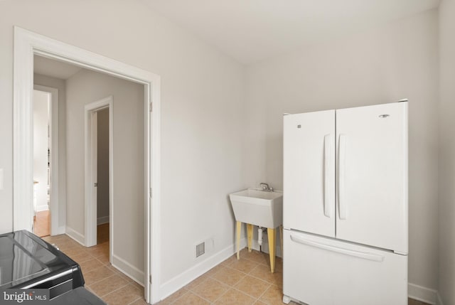 laundry room with light tile patterned flooring