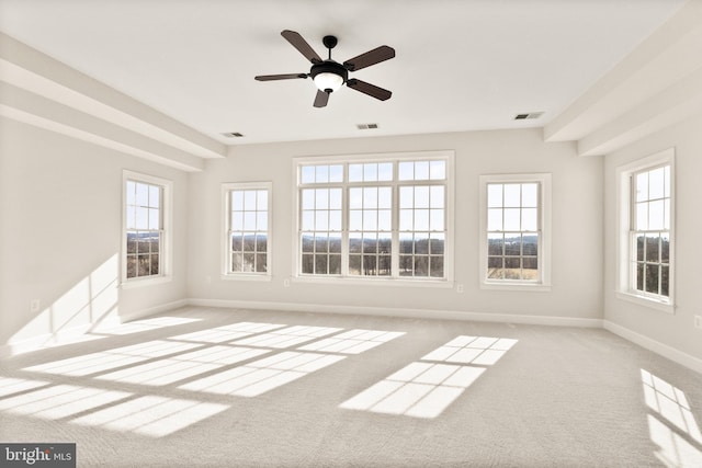 unfurnished sunroom with ceiling fan