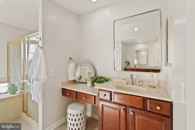 bathroom featuring a shower with door, vanity, and tile patterned floors