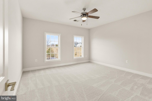 empty room with ceiling fan and light colored carpet