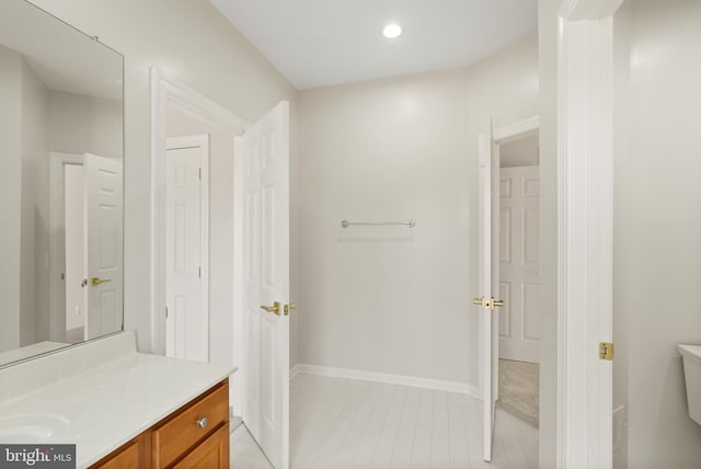 bathroom featuring vanity and toilet