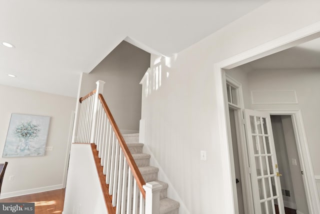 staircase featuring hardwood / wood-style floors