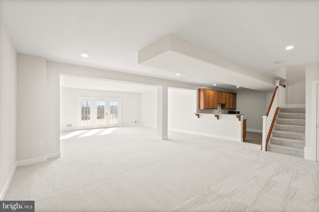 basement with light carpet and french doors