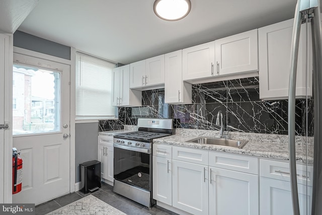 kitchen with white cabinets, sink, and stainless steel range with gas stovetop