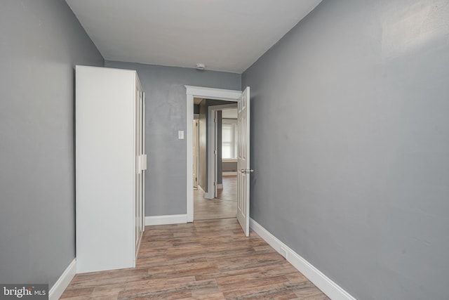 hallway with light hardwood / wood-style floors