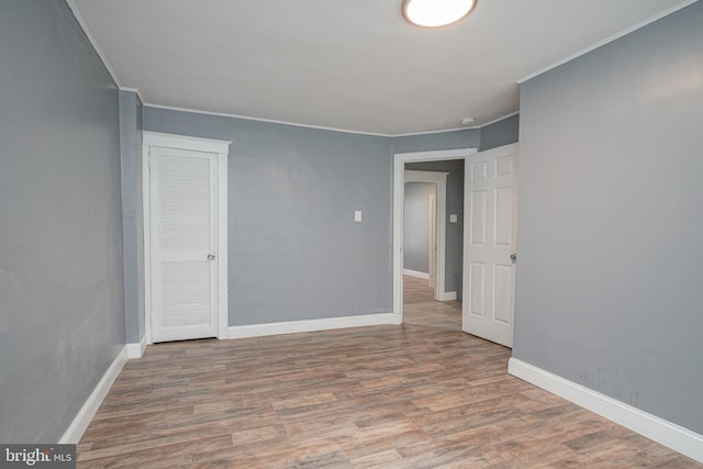 unfurnished room featuring hardwood / wood-style flooring and ornamental molding