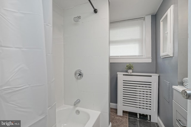 bathroom featuring radiator, tile patterned floors, and shower / bathtub combination